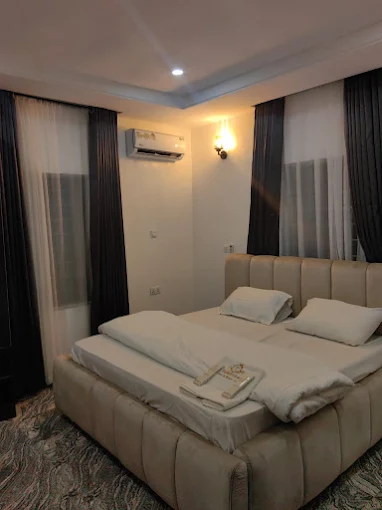Room with big bed in peach color