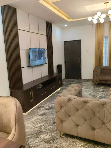 Living room with brown settings and TV left side view